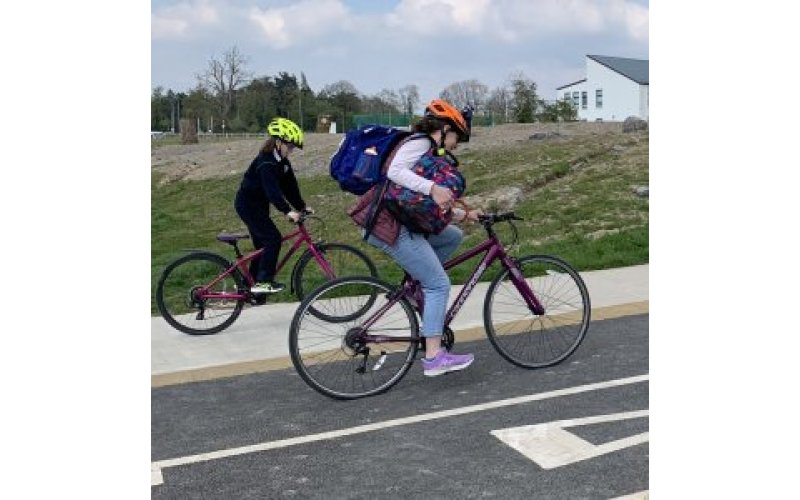 Two people cycling on a cycleway