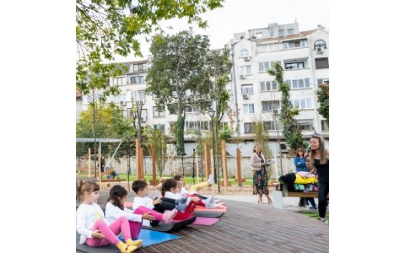 Children doing yoga on mats with an adult instructor